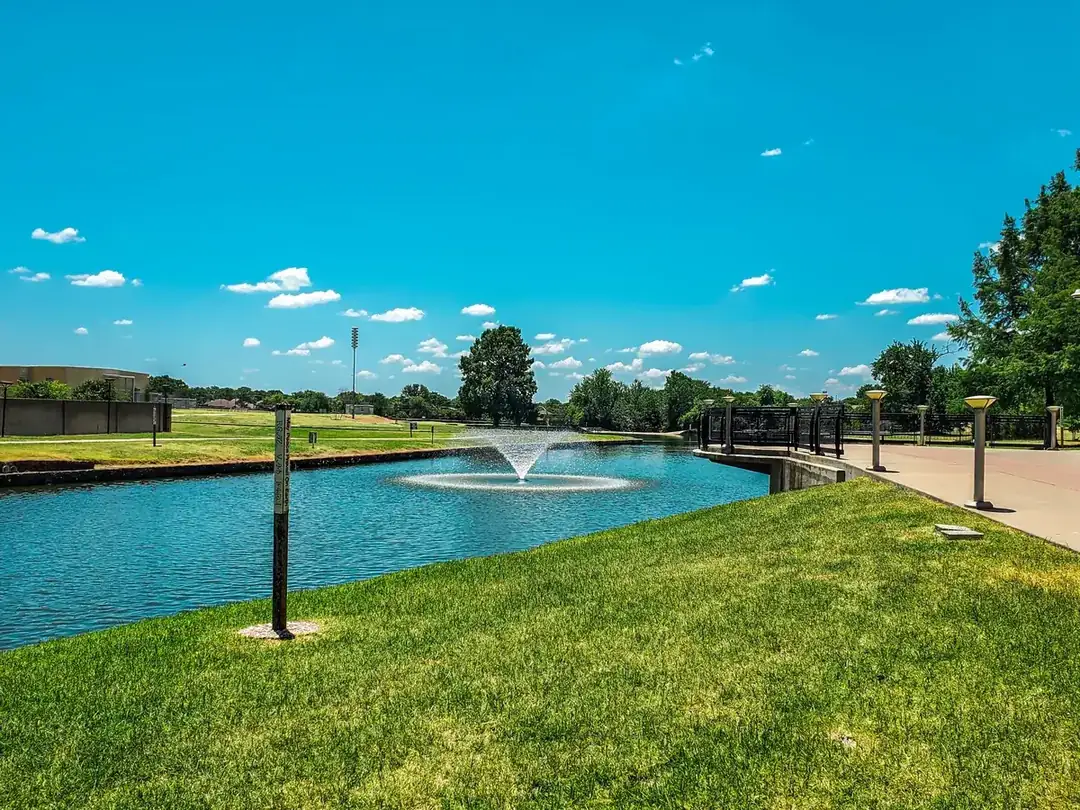 Park pond with a fountain on a sunny day